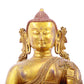 A solemn gilt bronze statue of Gautama Buddha