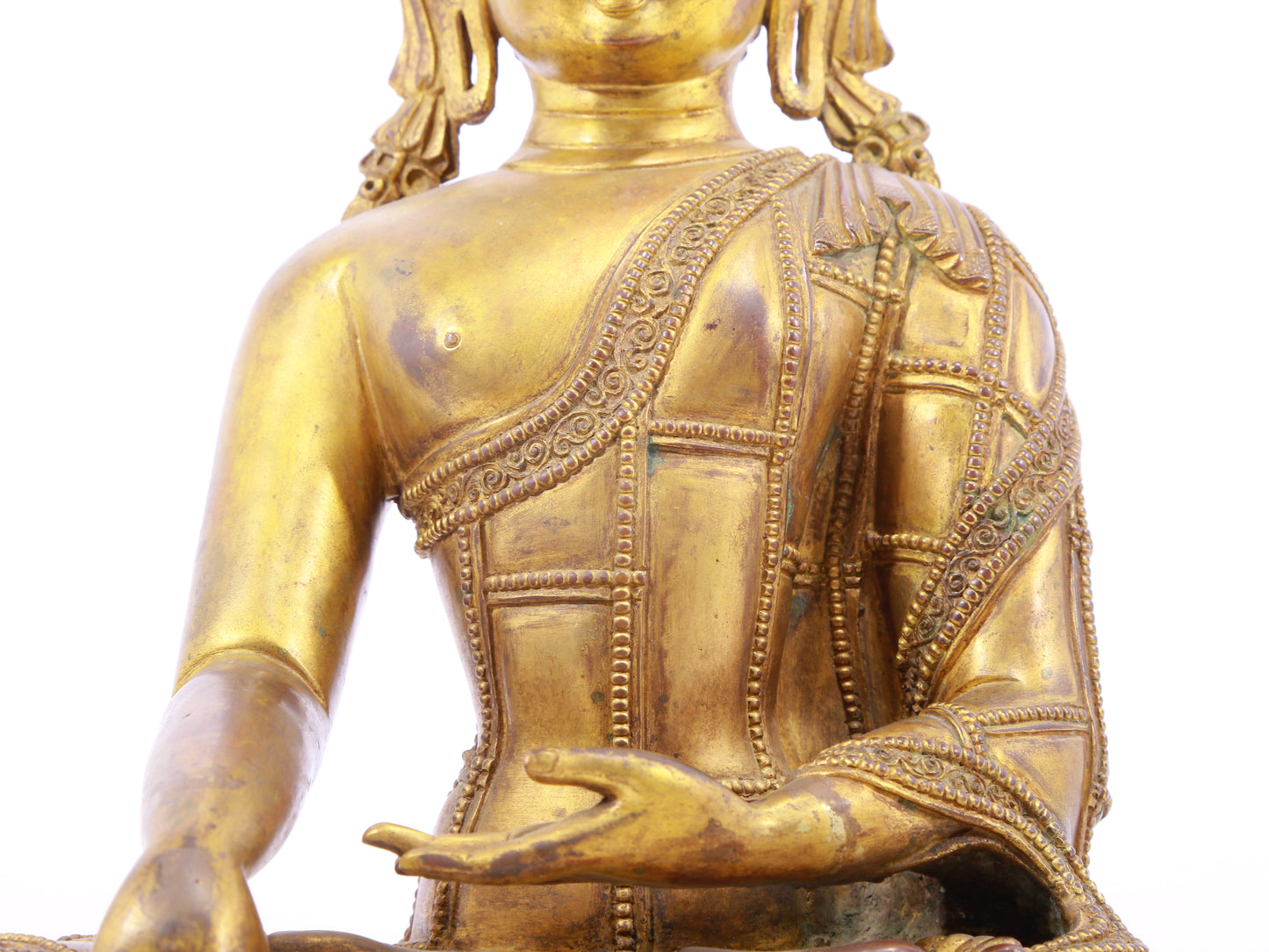 A solemn gilt bronze statue of Gautama Buddha