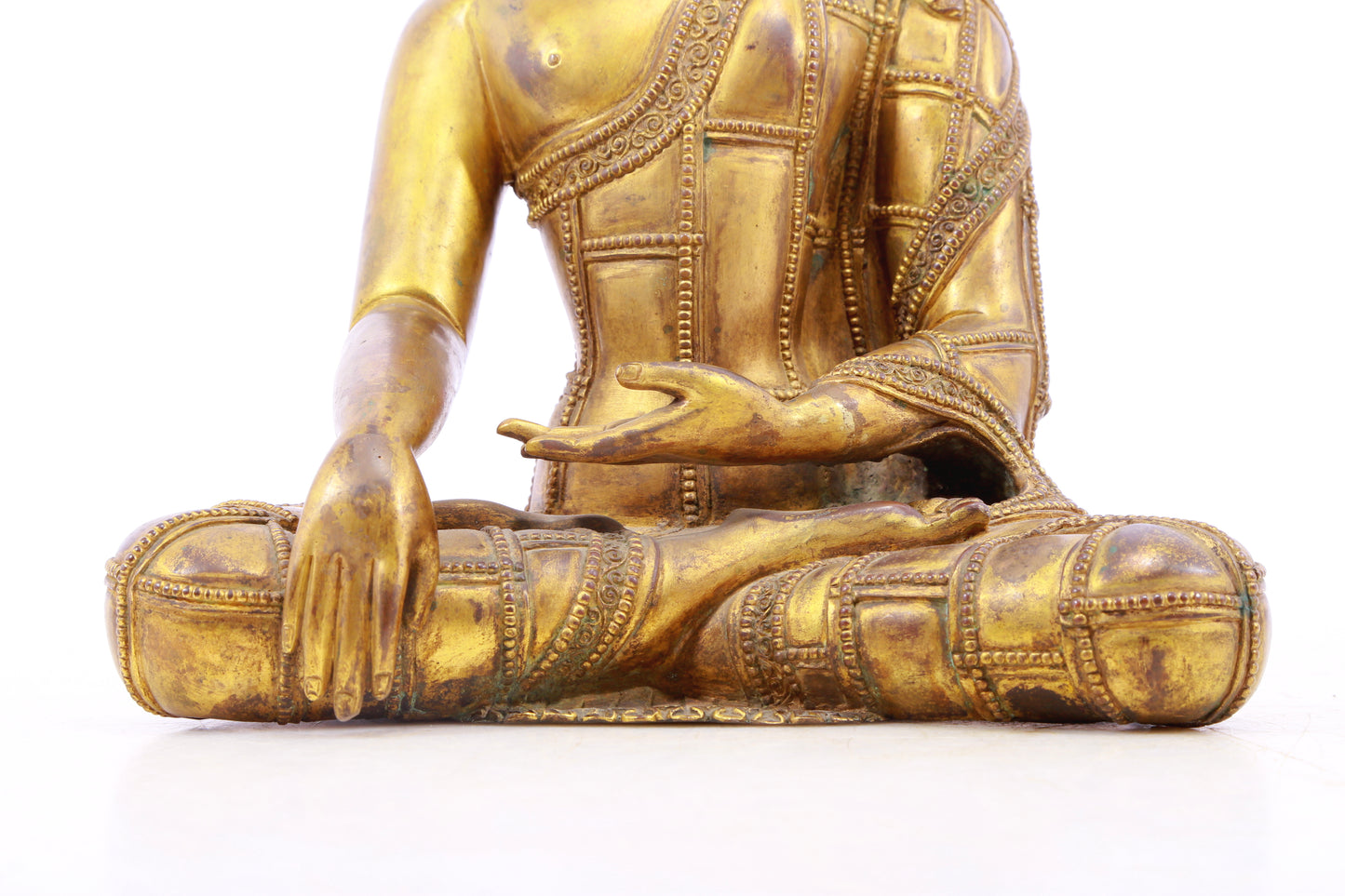 A solemn gilt bronze statue of Gautama Buddha