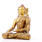 A solemn gilt bronze statue of Gautama Buddha