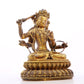 A serene gilt bronze statue of Manjusri with four arms