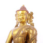 A solemn gilt bronze statue of Gautama Buddha