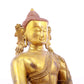 A solemn gilt bronze statue of Gautama Buddha