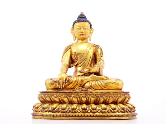 A solemn gilt bronze statue of Gautama Buddha