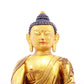 A solemn gilt bronze statue of Gautama Buddha