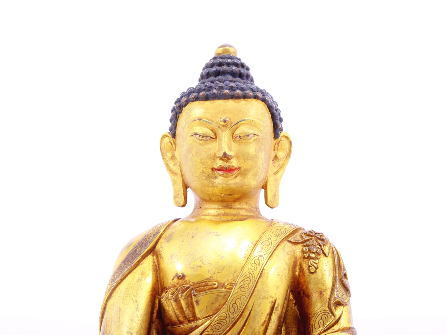 A solemn gilt bronze statue of Gautama Buddha