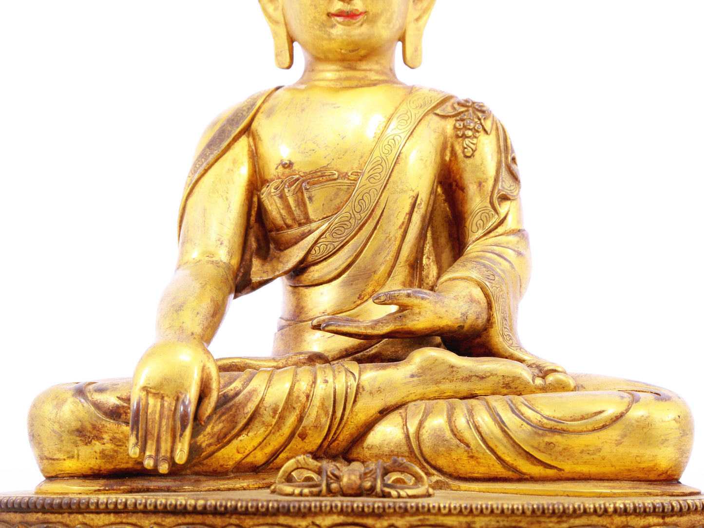 A solemn gilt bronze statue of Gautama Buddha