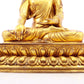 A solemn gilt bronze statue of Gautama Buddha