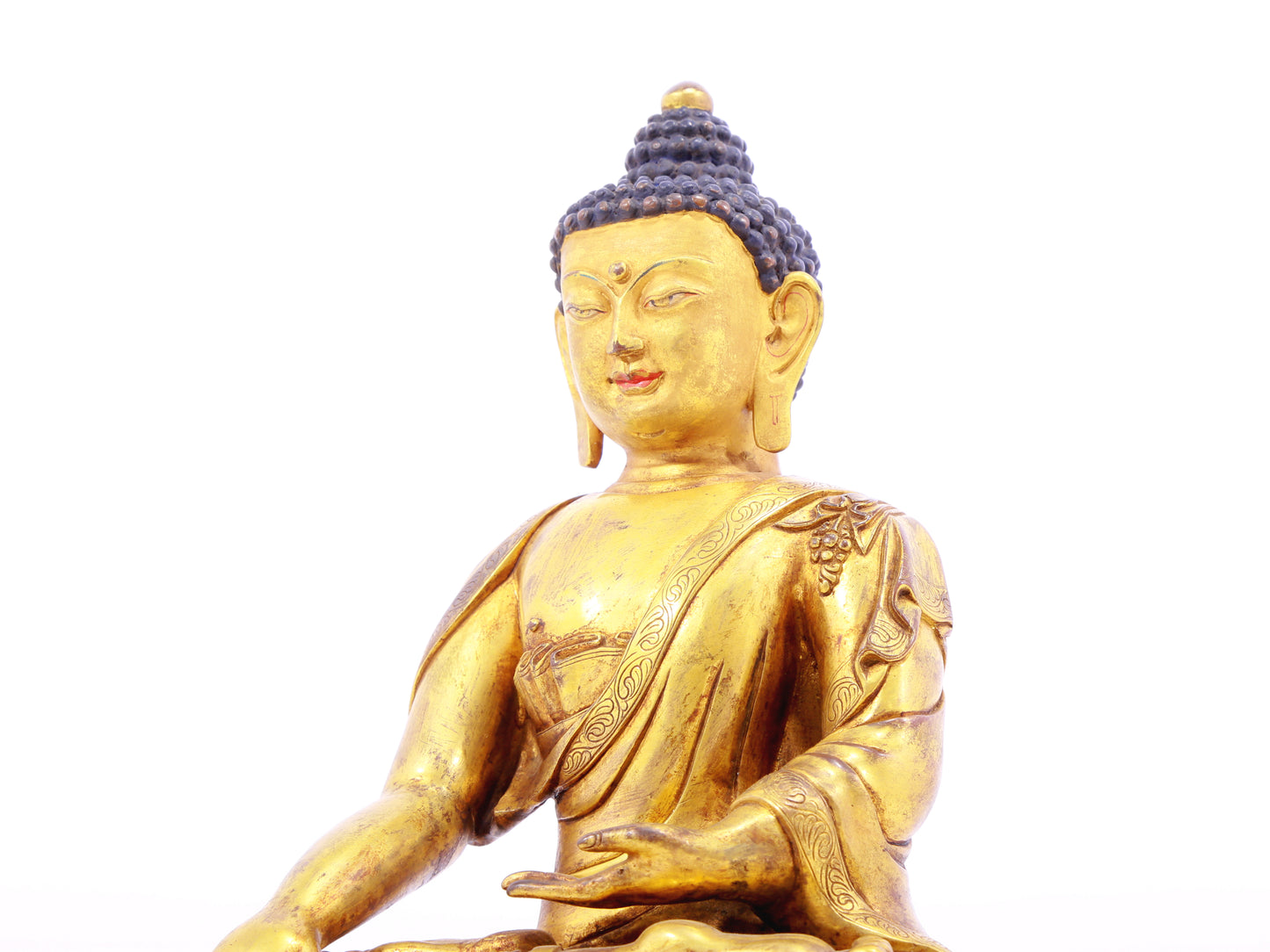 A solemn gilt bronze statue of Gautama Buddha