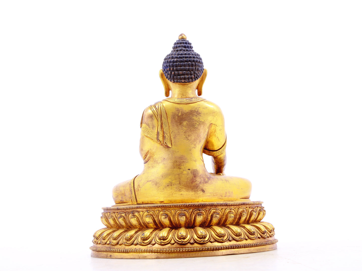 A solemn gilt bronze statue of Gautama Buddha