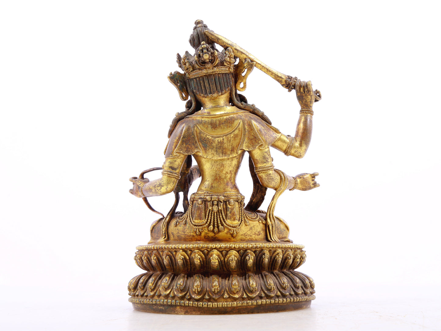 A serene gilt bronze statue of Manjusri with four arms