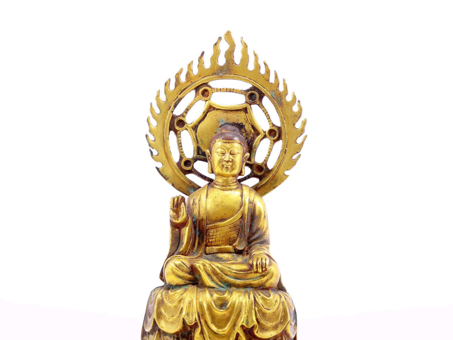 A solemn gilt bronze statue of Gautama Buddha