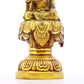 A solemn gilt bronze statue of Gautama Buddha