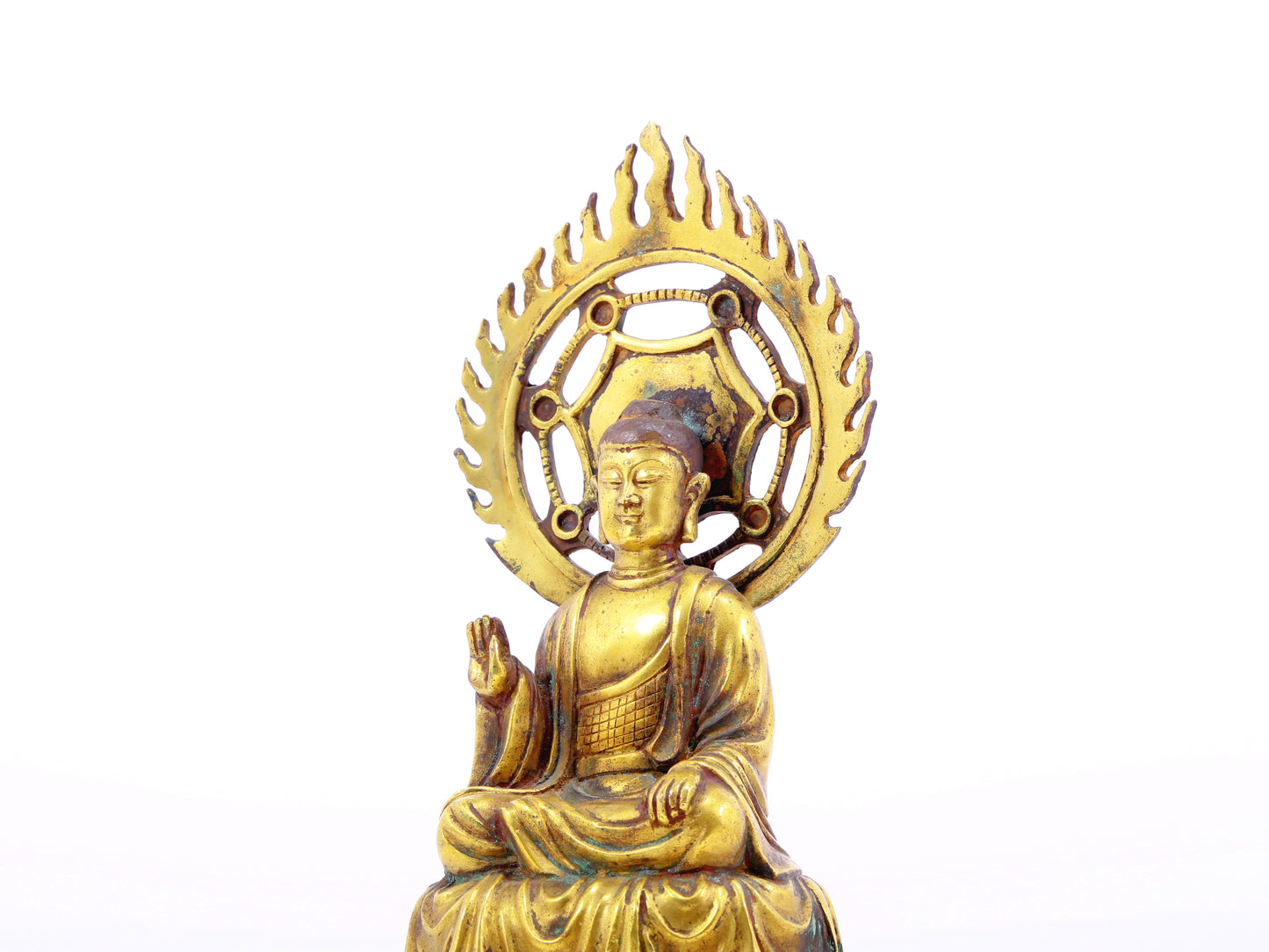 A solemn gilt bronze statue of Gautama Buddha