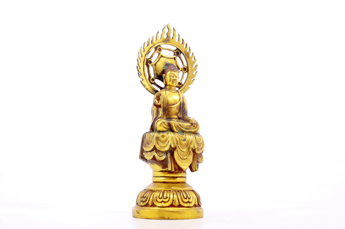 A solemn gilt bronze statue of Gautama Buddha