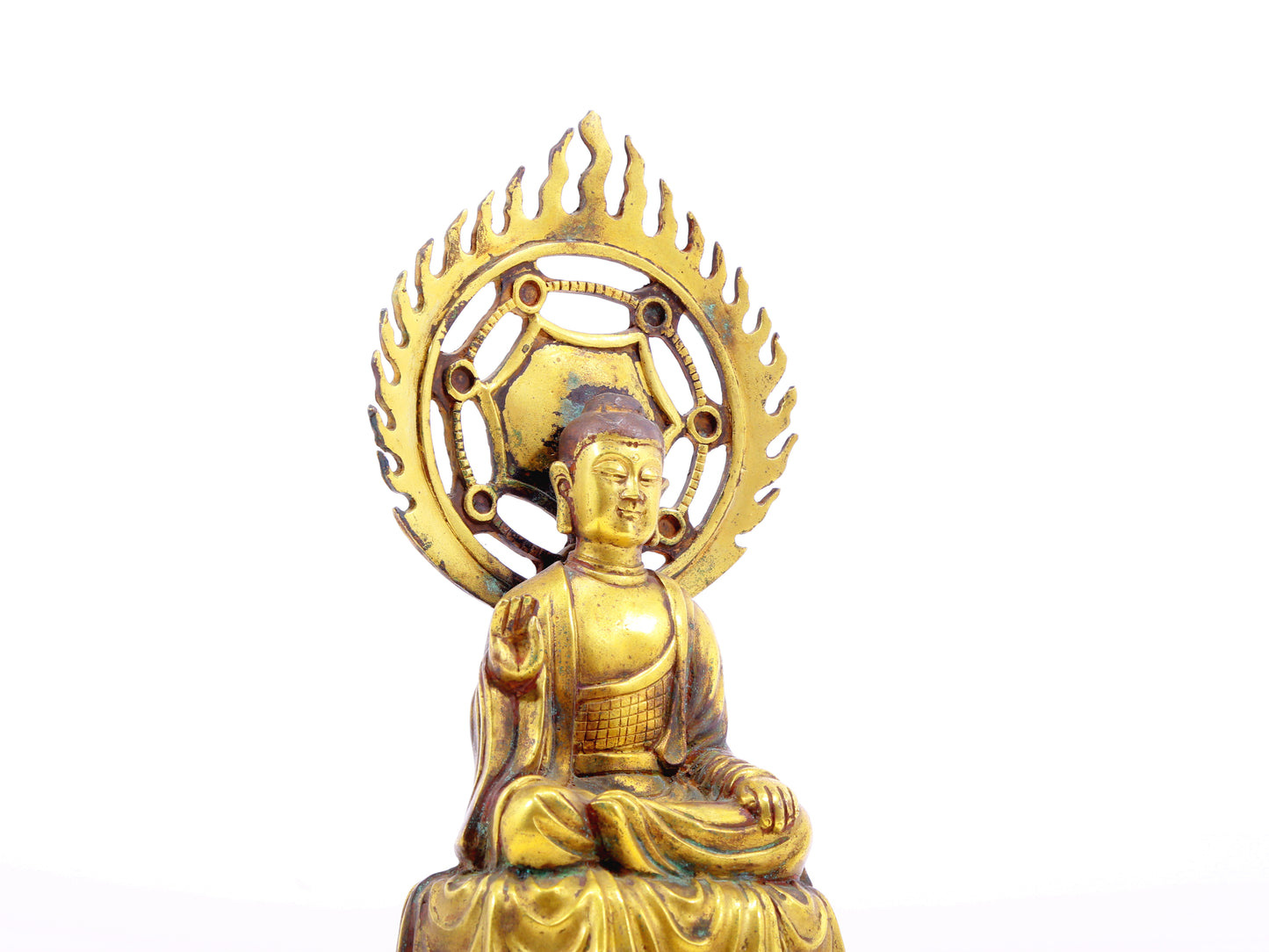 A solemn gilt bronze statue of Gautama Buddha