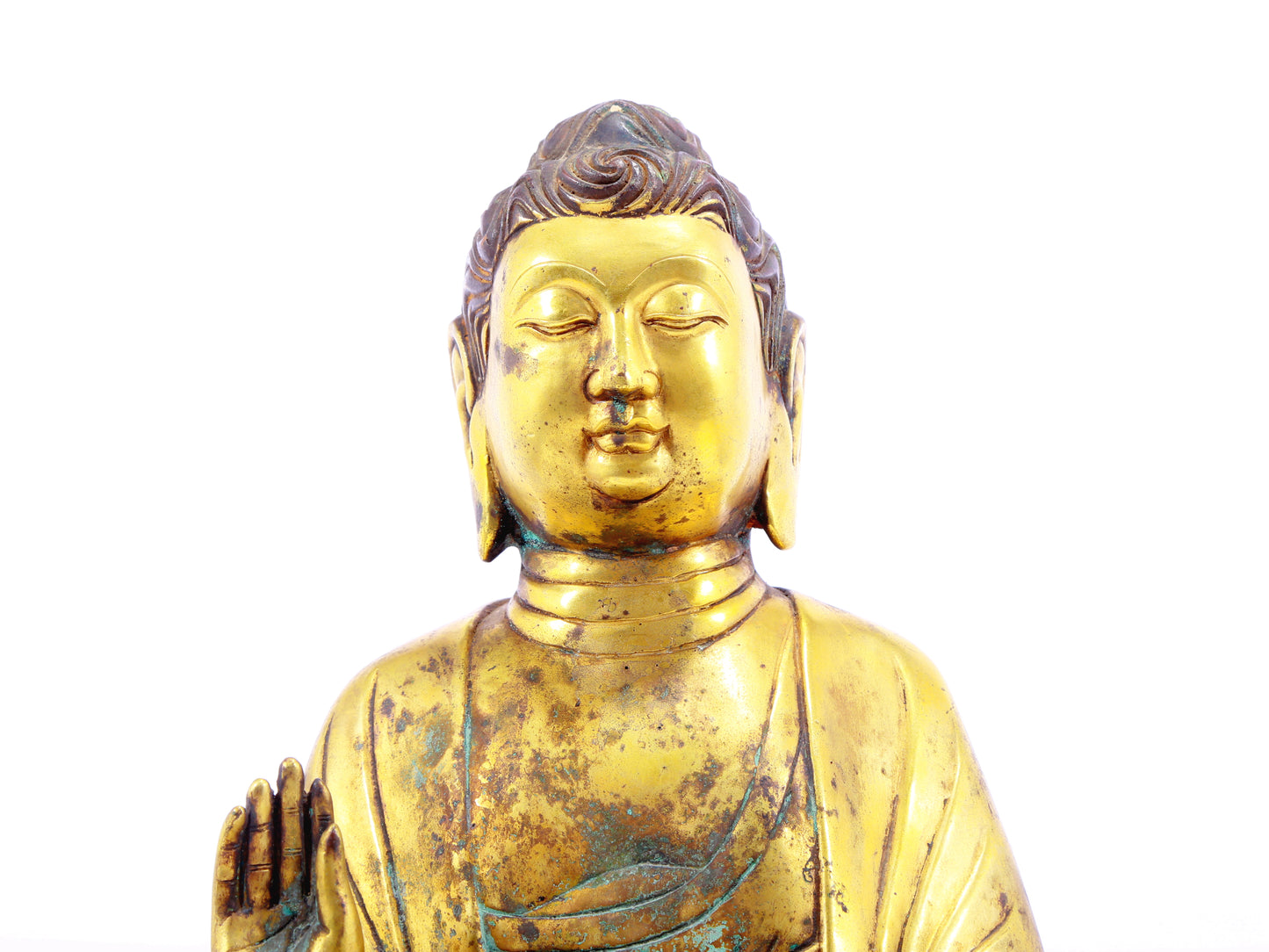 A solemn gilt bronze statue of Gautama Buddha