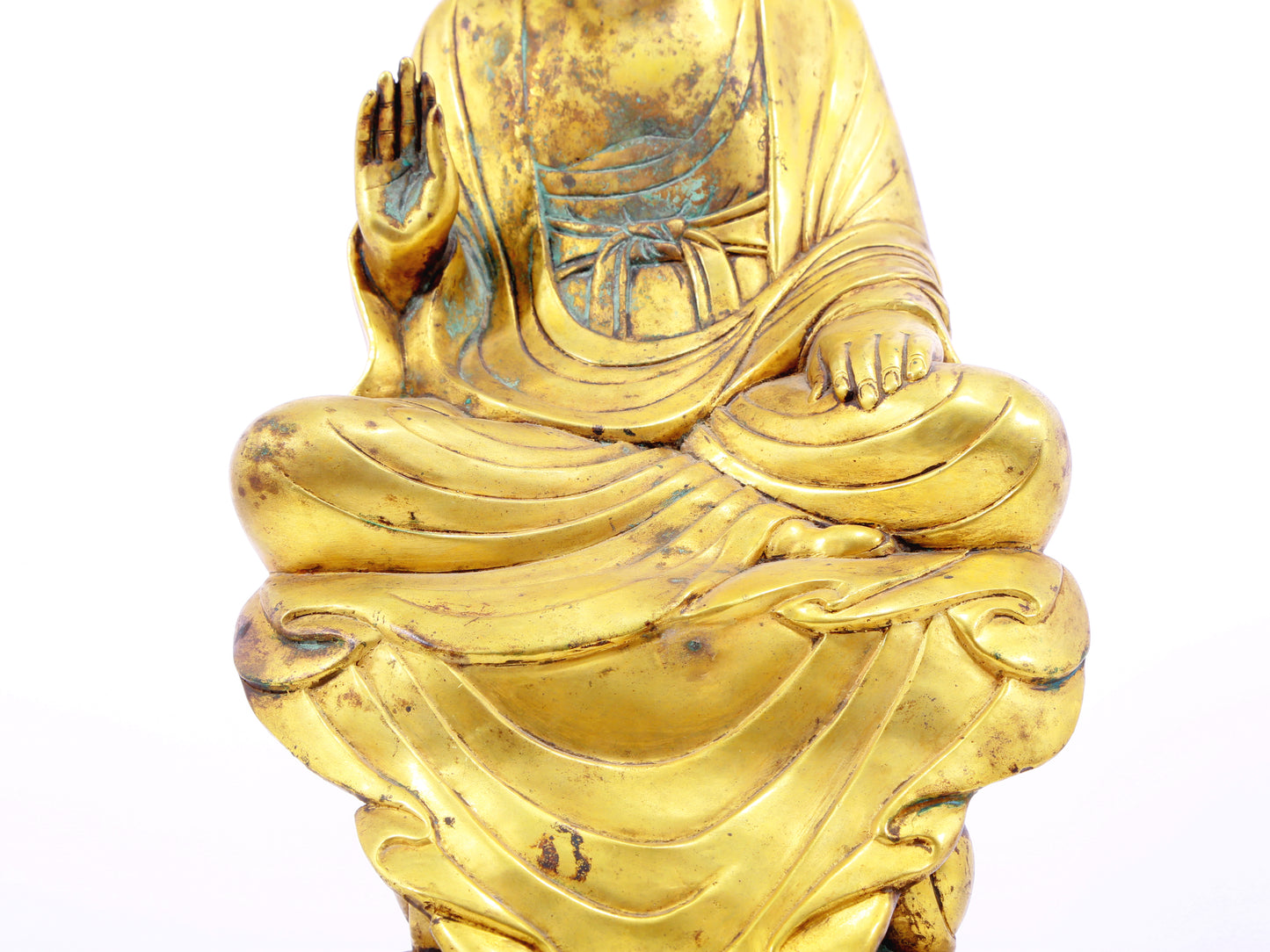 A solemn gilt bronze statue of Gautama Buddha