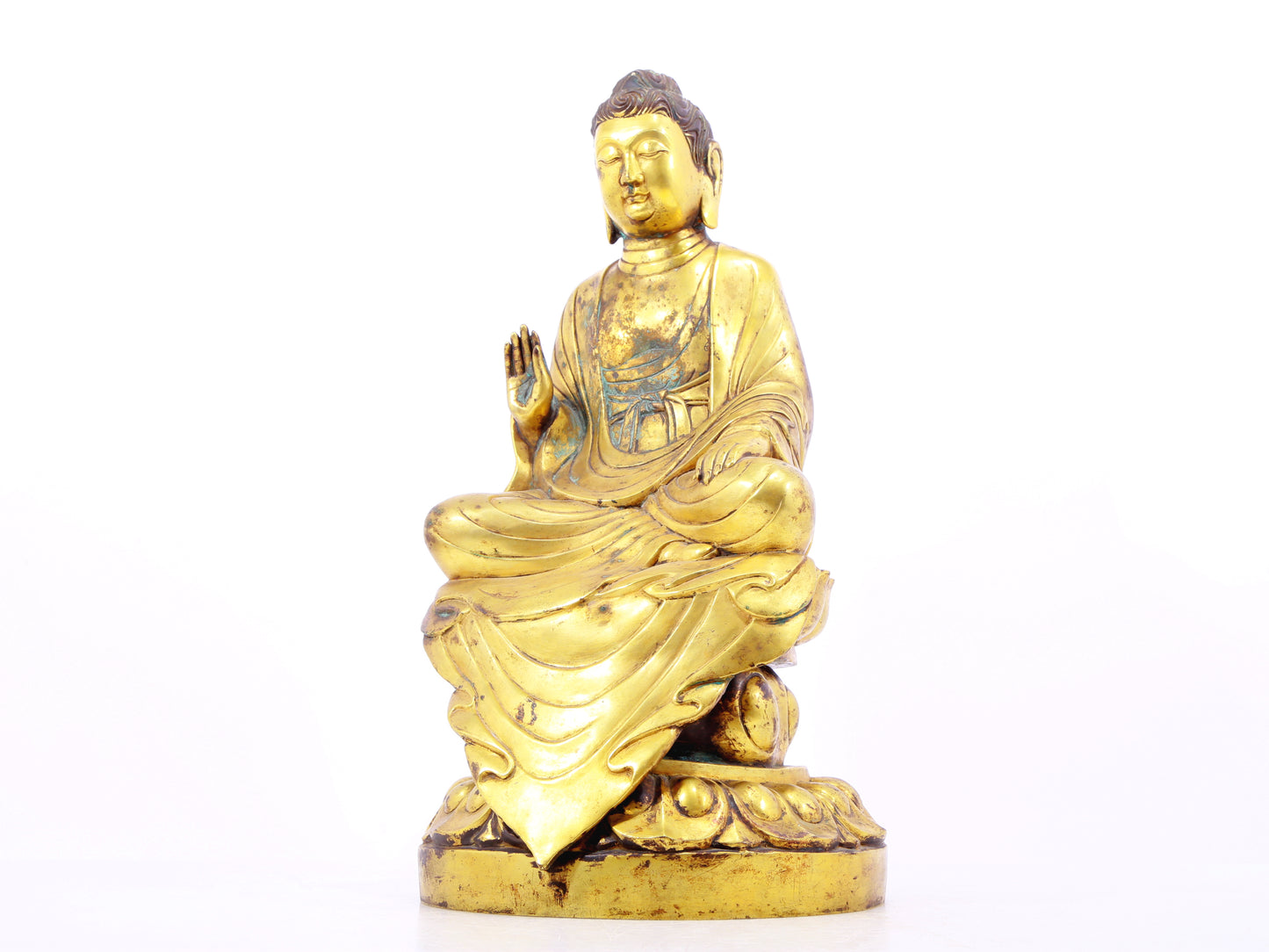 A solemn gilt bronze statue of Gautama Buddha