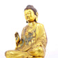 A solemn gilt bronze statue of Gautama Buddha