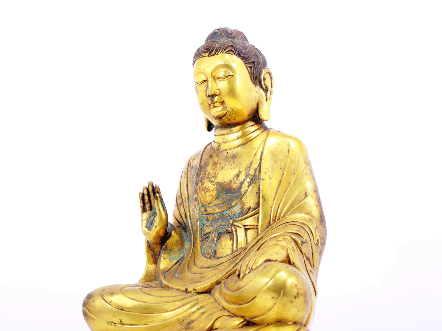 A solemn gilt bronze statue of Gautama Buddha