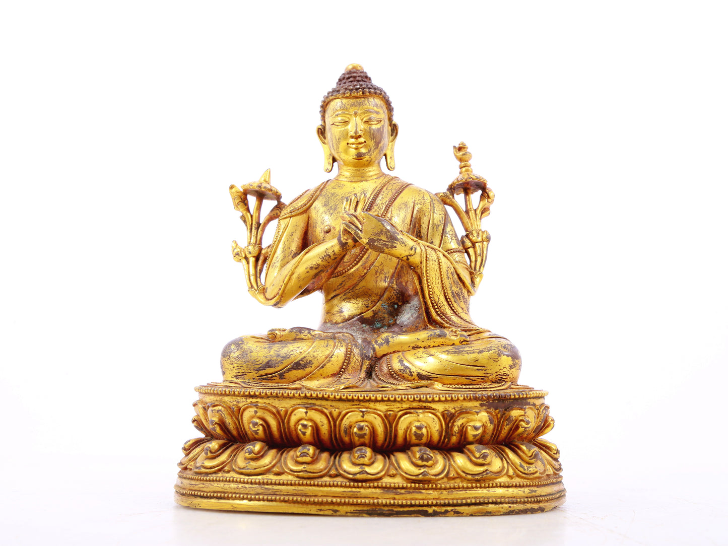 A serene gilt bronze statue of Gautama Buddha