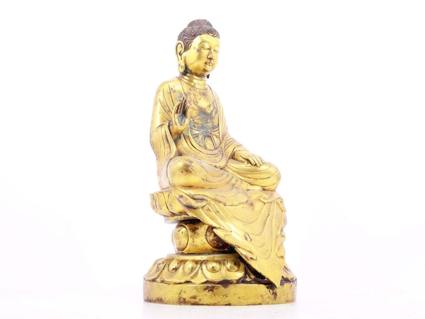 A solemn gilt bronze statue of Gautama Buddha