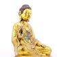 A solemn gilt bronze statue of Gautama Buddha