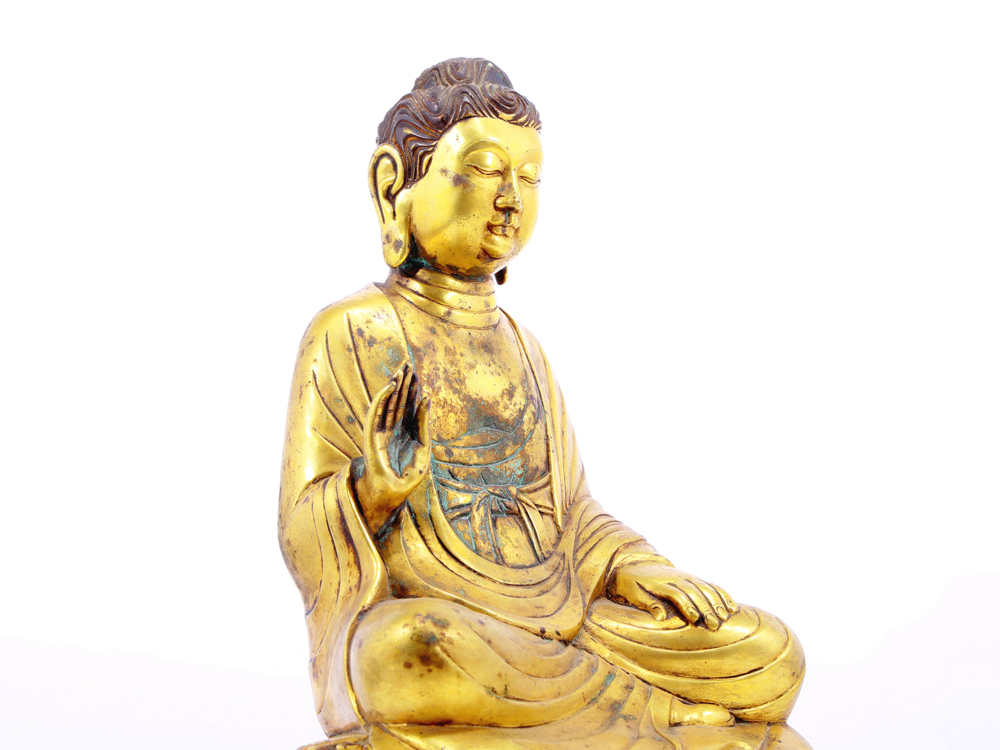 A solemn gilt bronze statue of Gautama Buddha