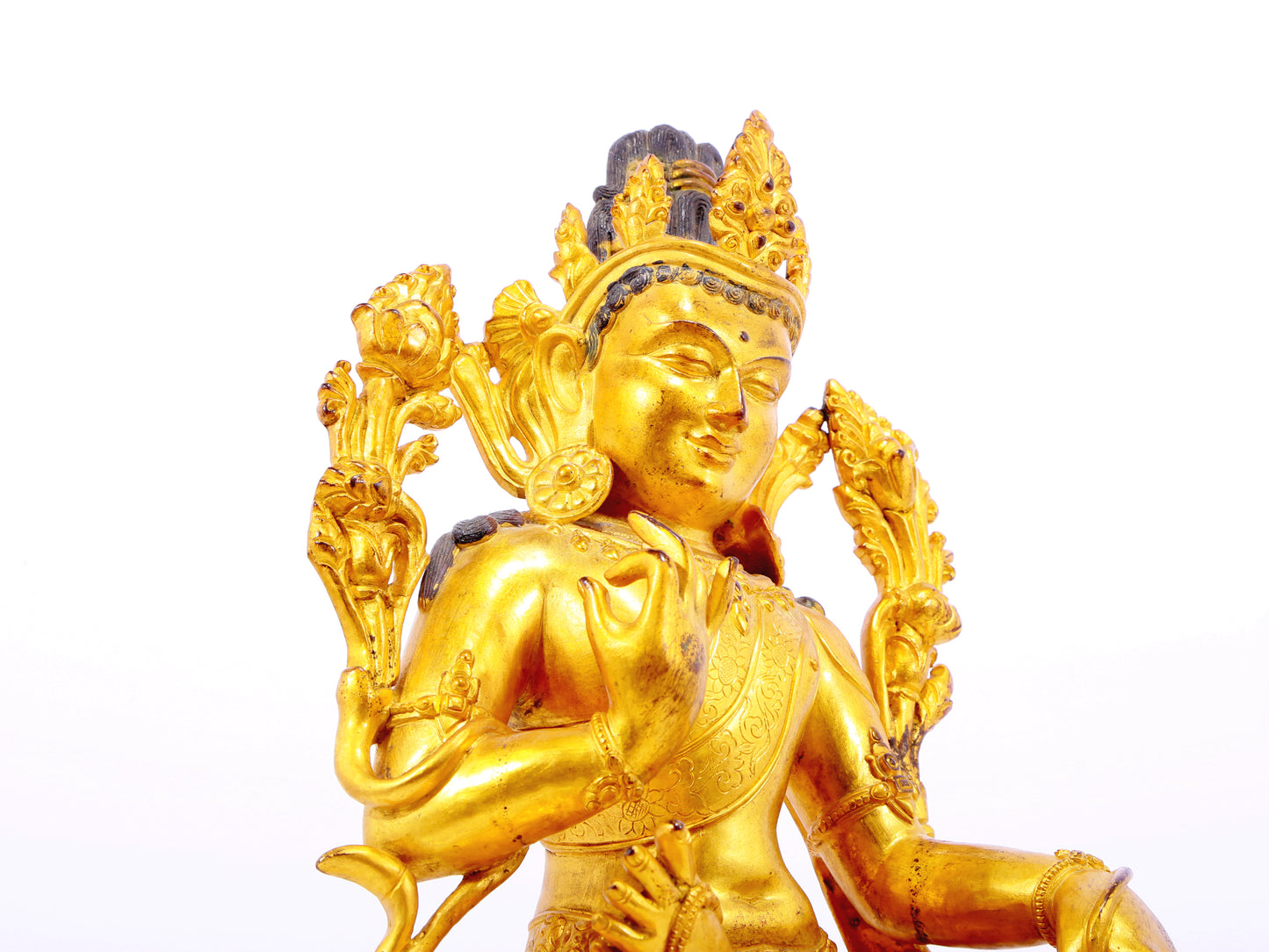 A solemn gilt bronze statue of green Tara