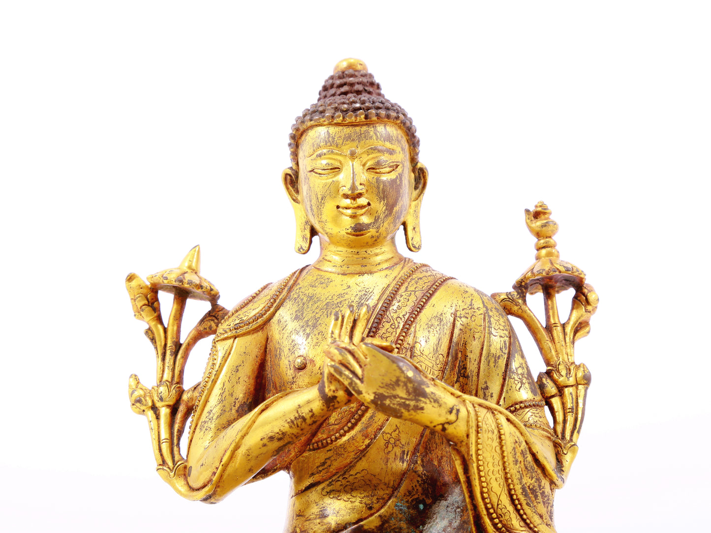 A serene gilt bronze statue of Gautama Buddha