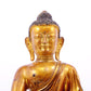 A solemn gilt bronze statue of Gautama Buddha