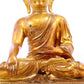 A solemn gilt bronze statue of Gautama Buddha