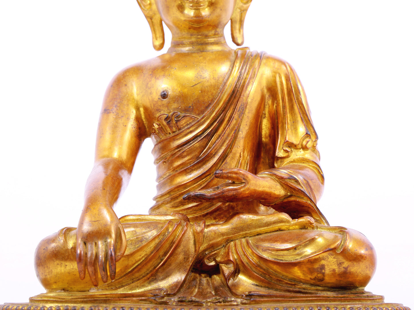 A solemn gilt bronze statue of Gautama Buddha