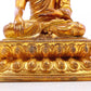 A solemn gilt bronze statue of Gautama Buddha