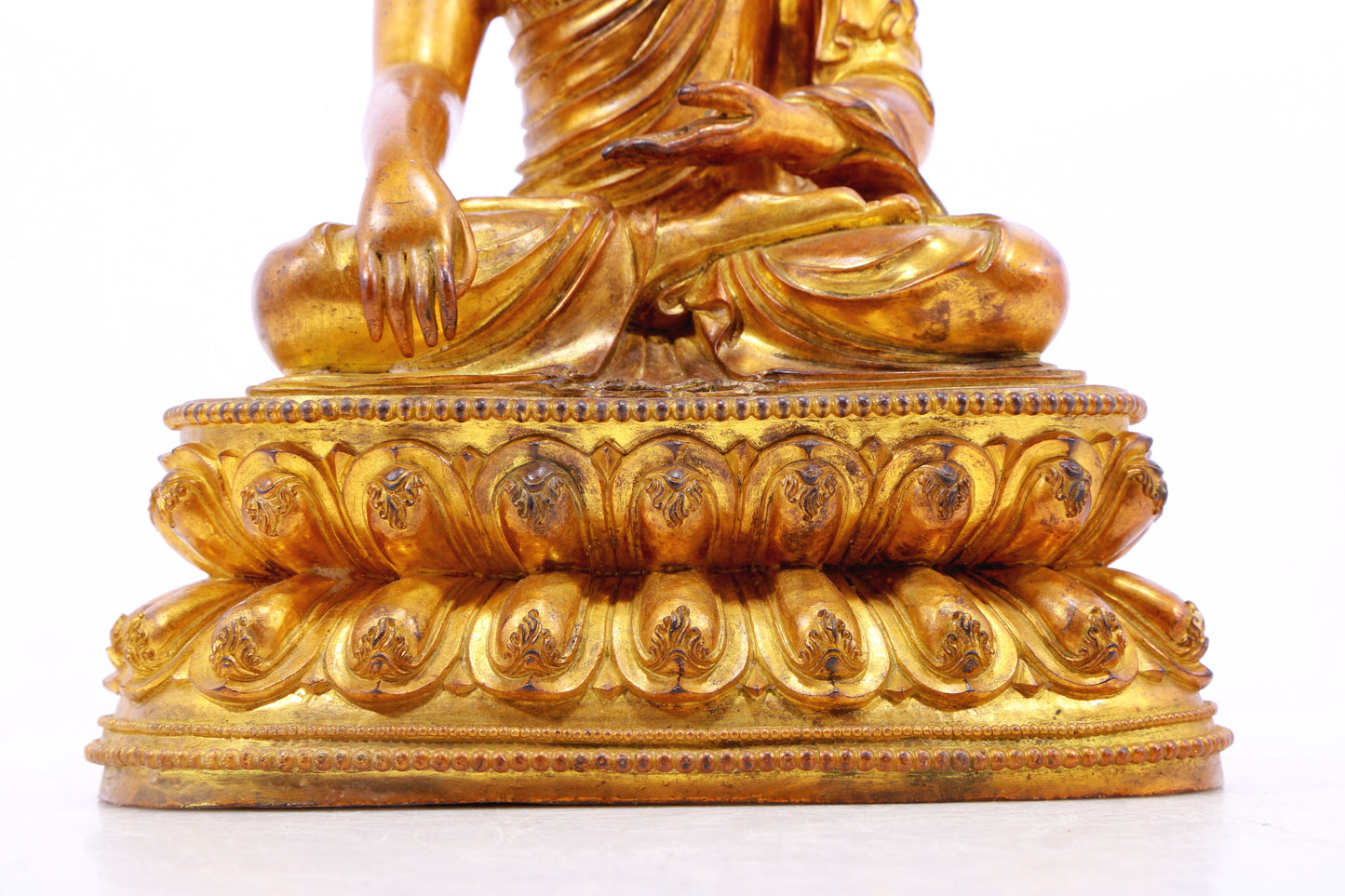 A solemn gilt bronze statue of Gautama Buddha