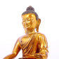 A solemn gilt bronze statue of Gautama Buddha