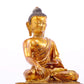 A solemn gilt bronze statue of Gautama Buddha