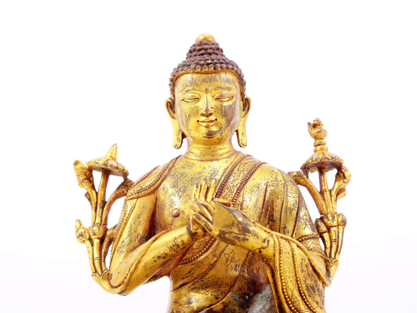 A serene gilt bronze statue of Gautama Buddha