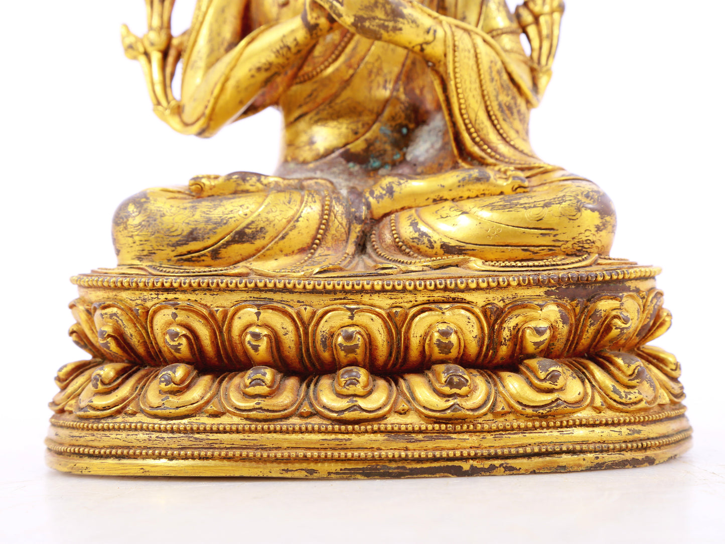 A serene gilt bronze statue of Gautama Buddha