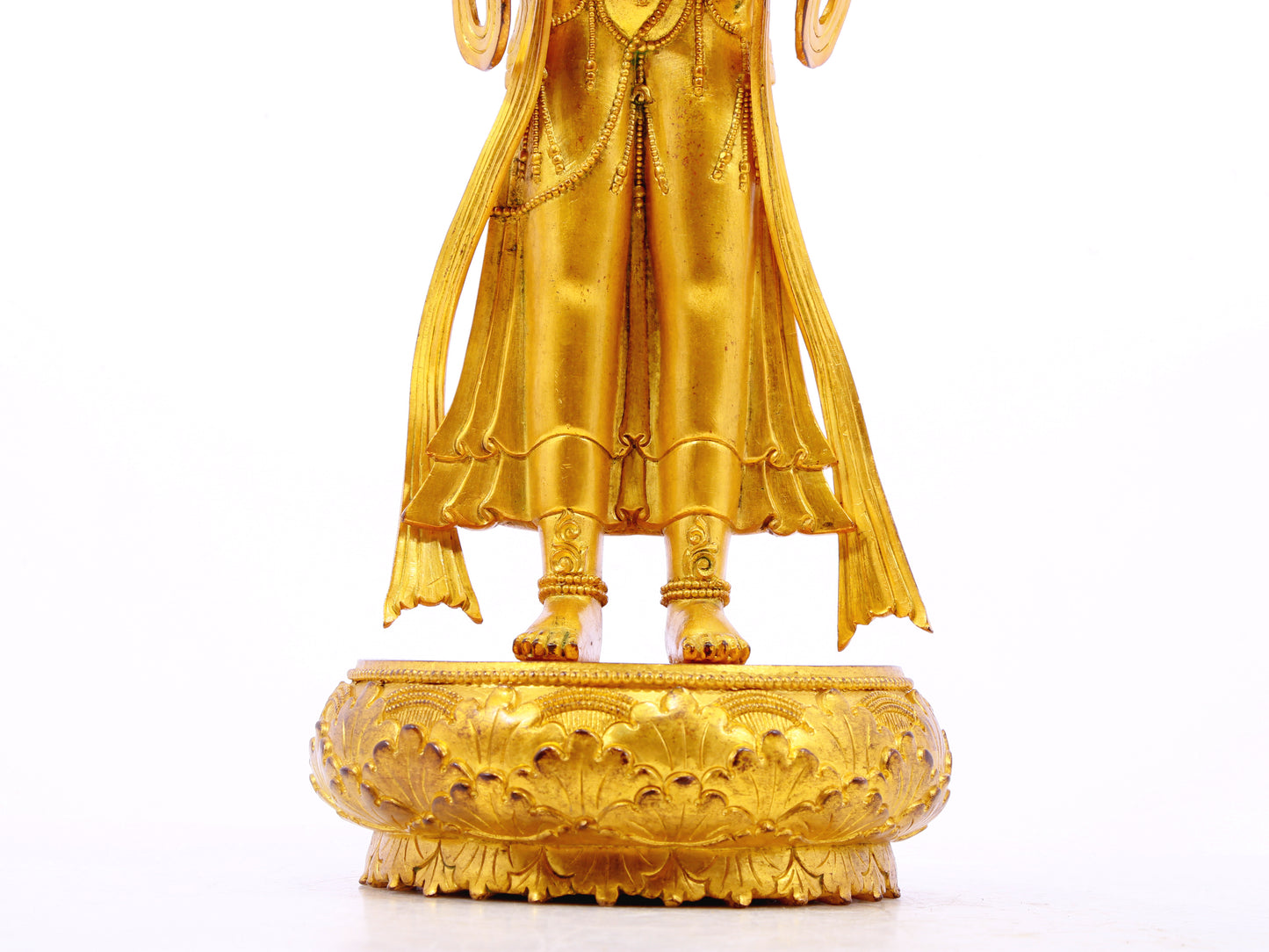 A solemn gilt bronze Bodhisattva stands