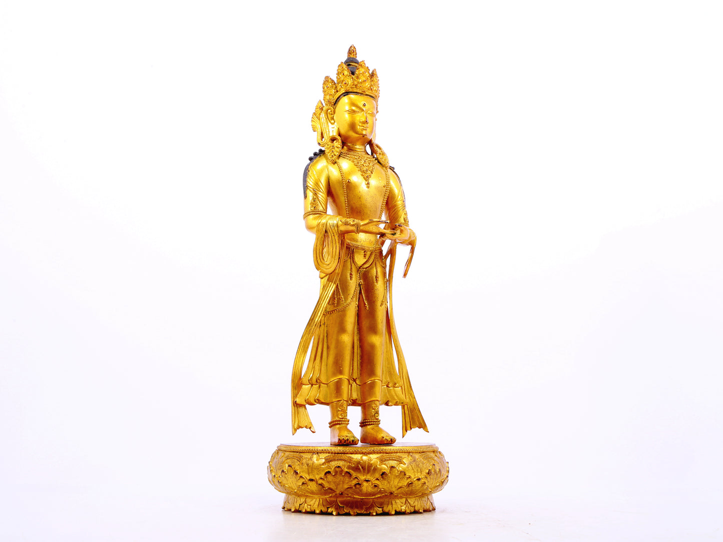 A solemn gilt bronze Bodhisattva stands