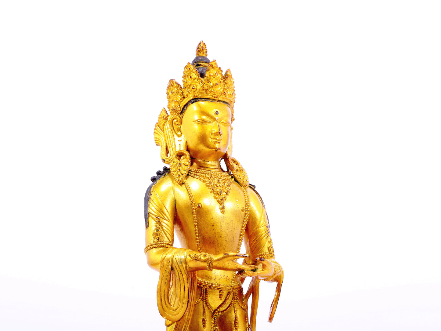 A solemn gilt bronze Bodhisattva stands