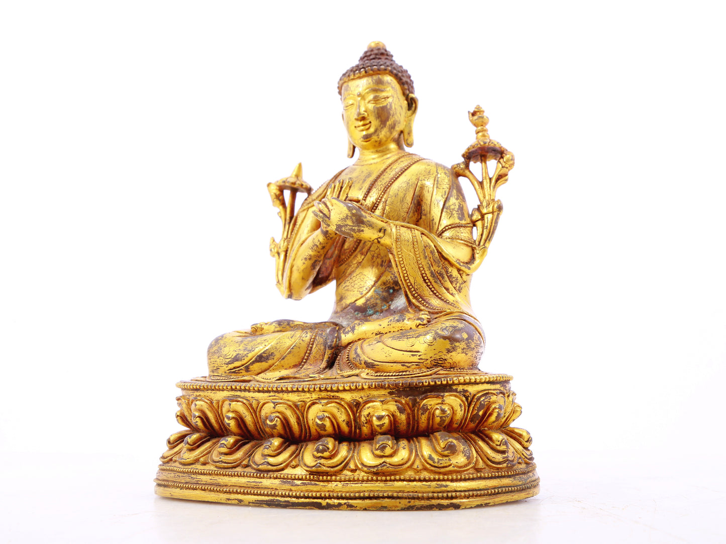 A serene gilt bronze statue of Gautama Buddha