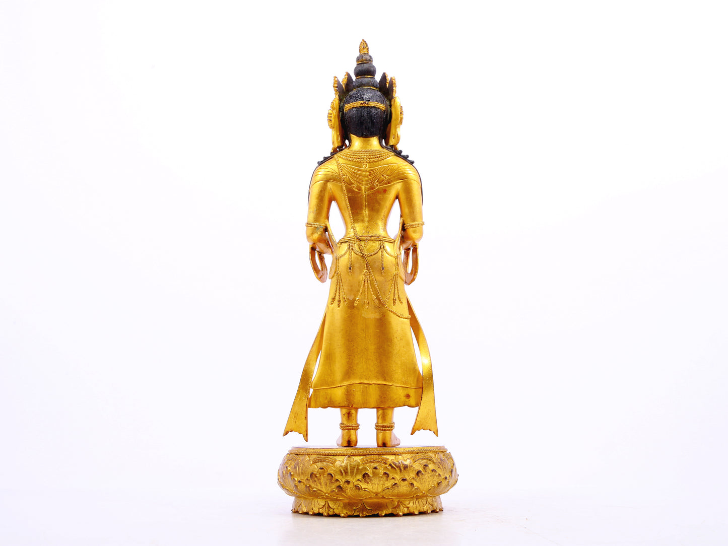 A solemn gilt bronze Bodhisattva stands