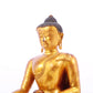 A solemn gilt bronze statue of Gautama Buddha