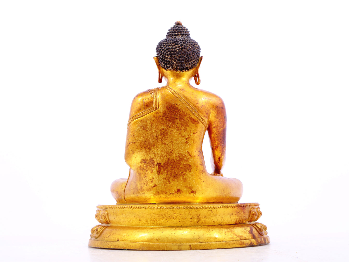 A solemn gilt bronze statue of Gautama Buddha