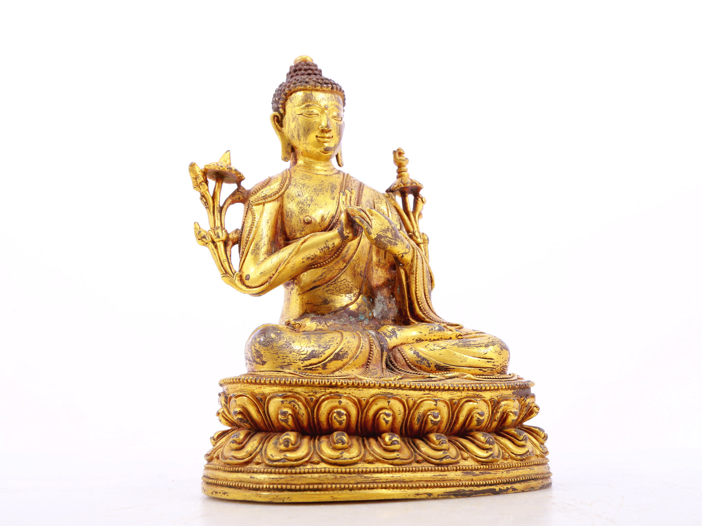 A serene gilt bronze statue of Gautama Buddha