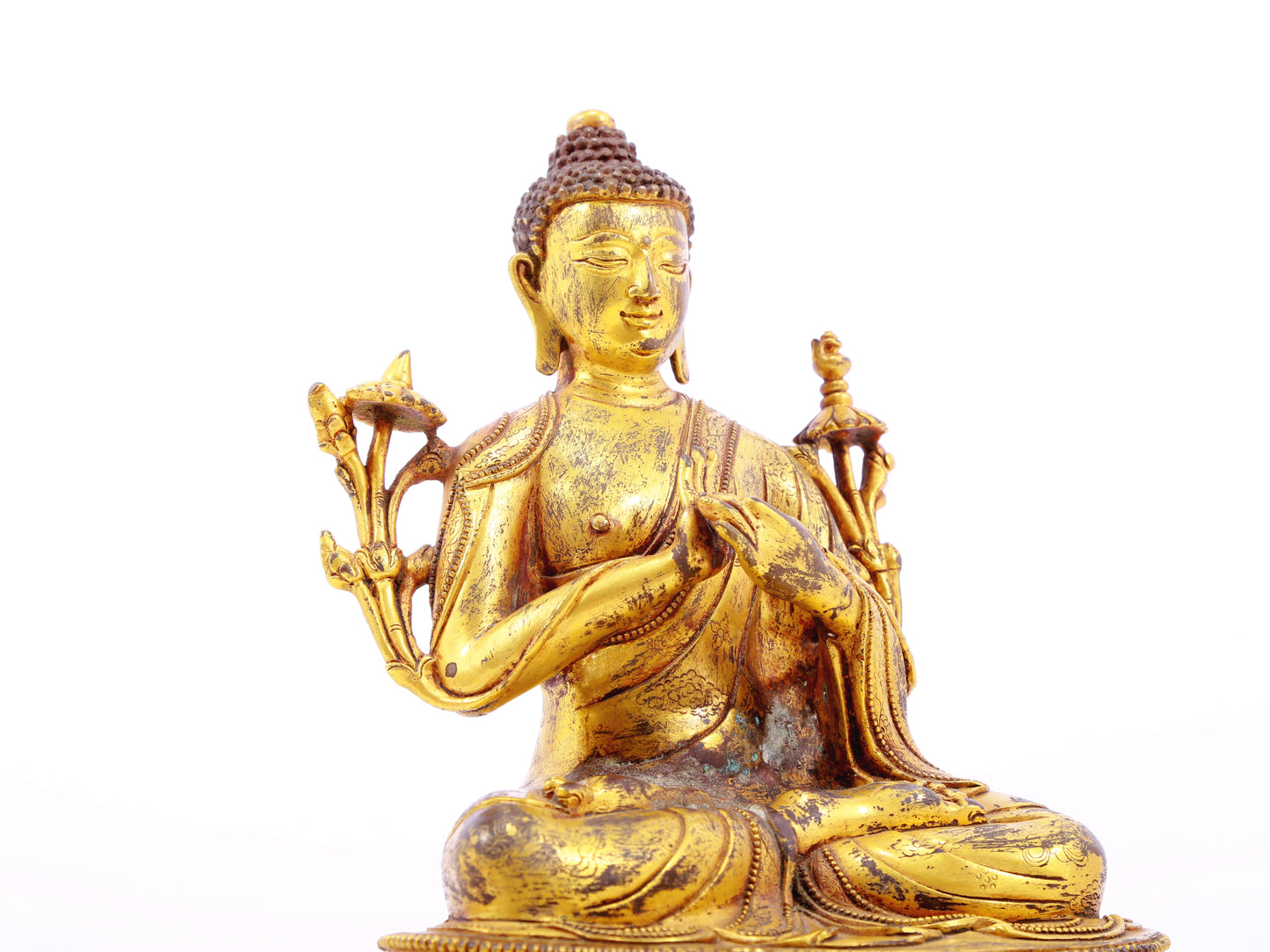 A serene gilt bronze statue of Gautama Buddha