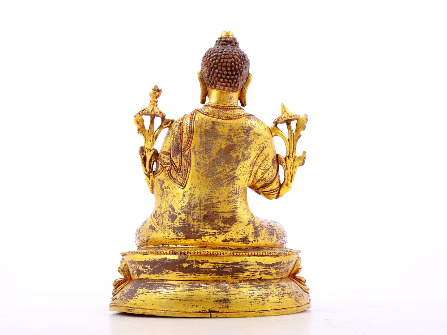 A serene gilt bronze statue of Gautama Buddha